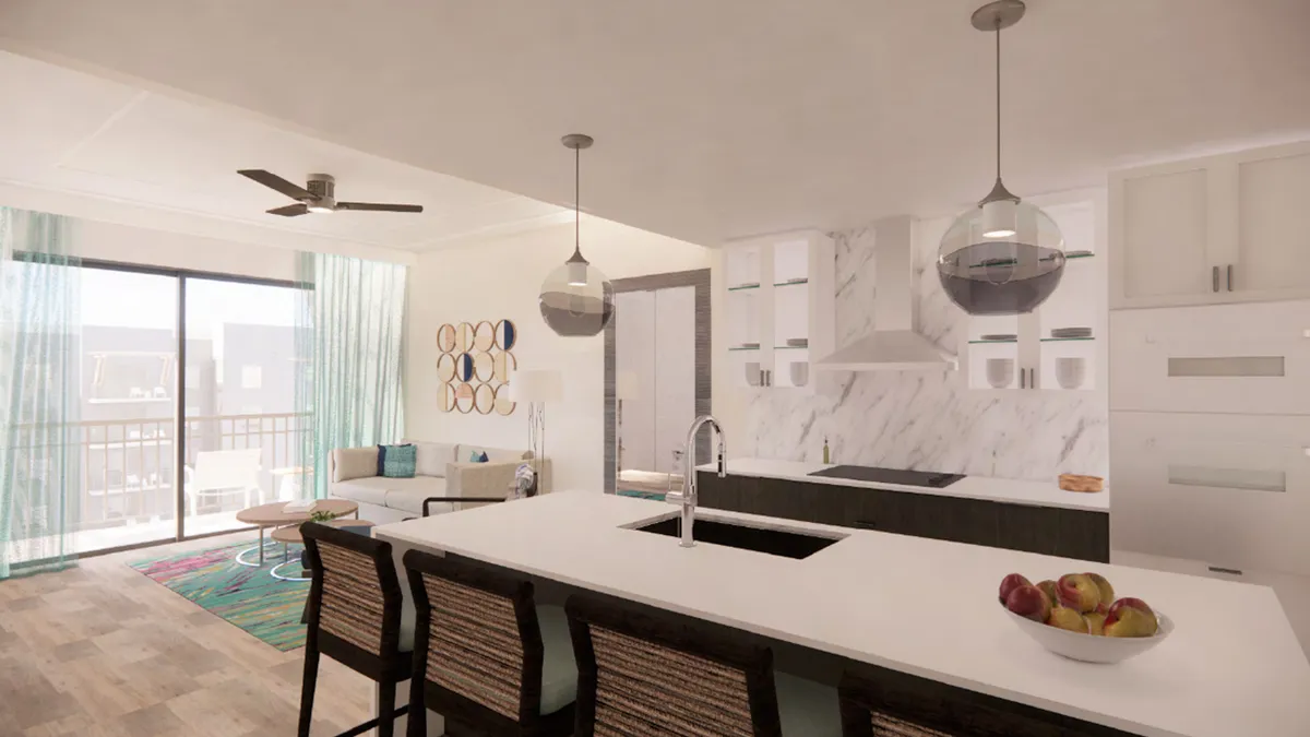 A spacious, sunlit open-plan living area seamlessly connects the living room, kitchen, and dining space. The room features a stylish sofa and chairs set up for conversation or relaxation, a kitchen island with upgraded appliances, large windows that flood the area with natural light, and vibrant wall art that adds a contemporary flair. The kitchen showcases a wine cooler and is arranged for group meal preparation and entertaining.